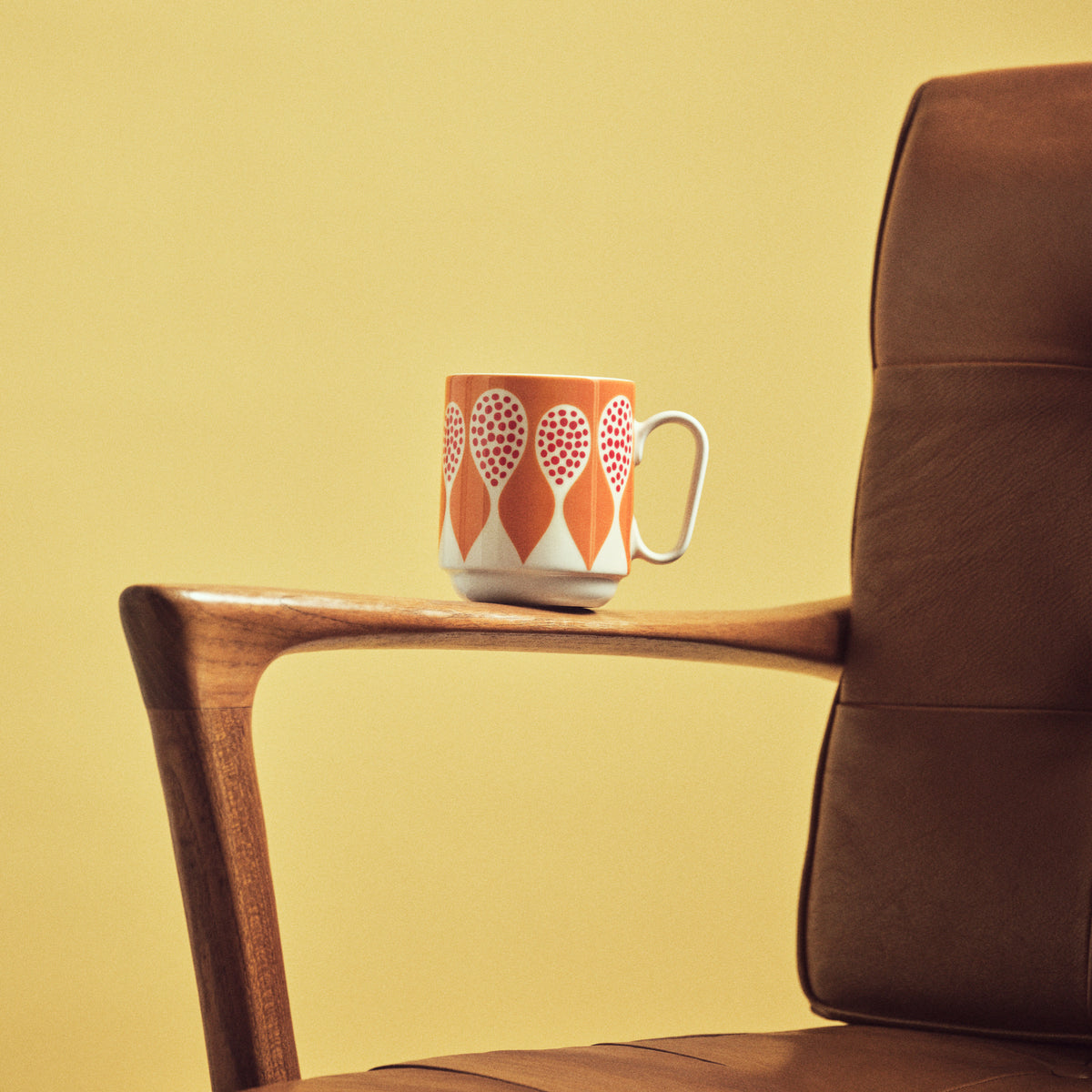 Mug with abstract design on arm chair.