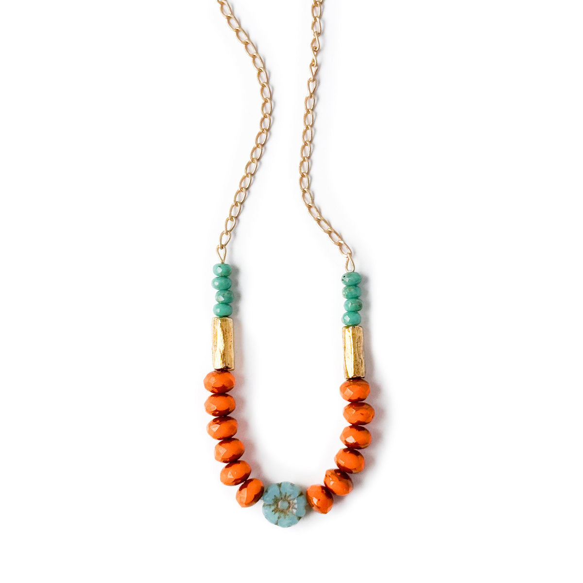 Necklace with orange and green beads on a white background