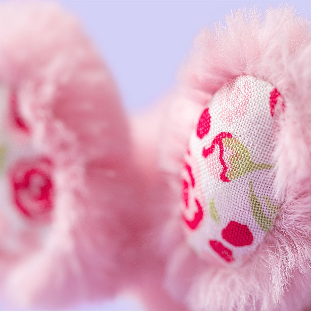 Close-up of bunny's feet with floral pattern on a blurred background