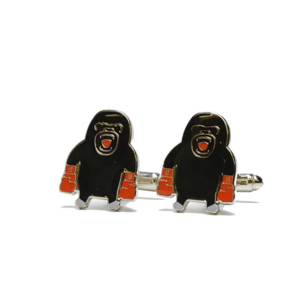 Gorilla-shaped cufflinks on a white background.