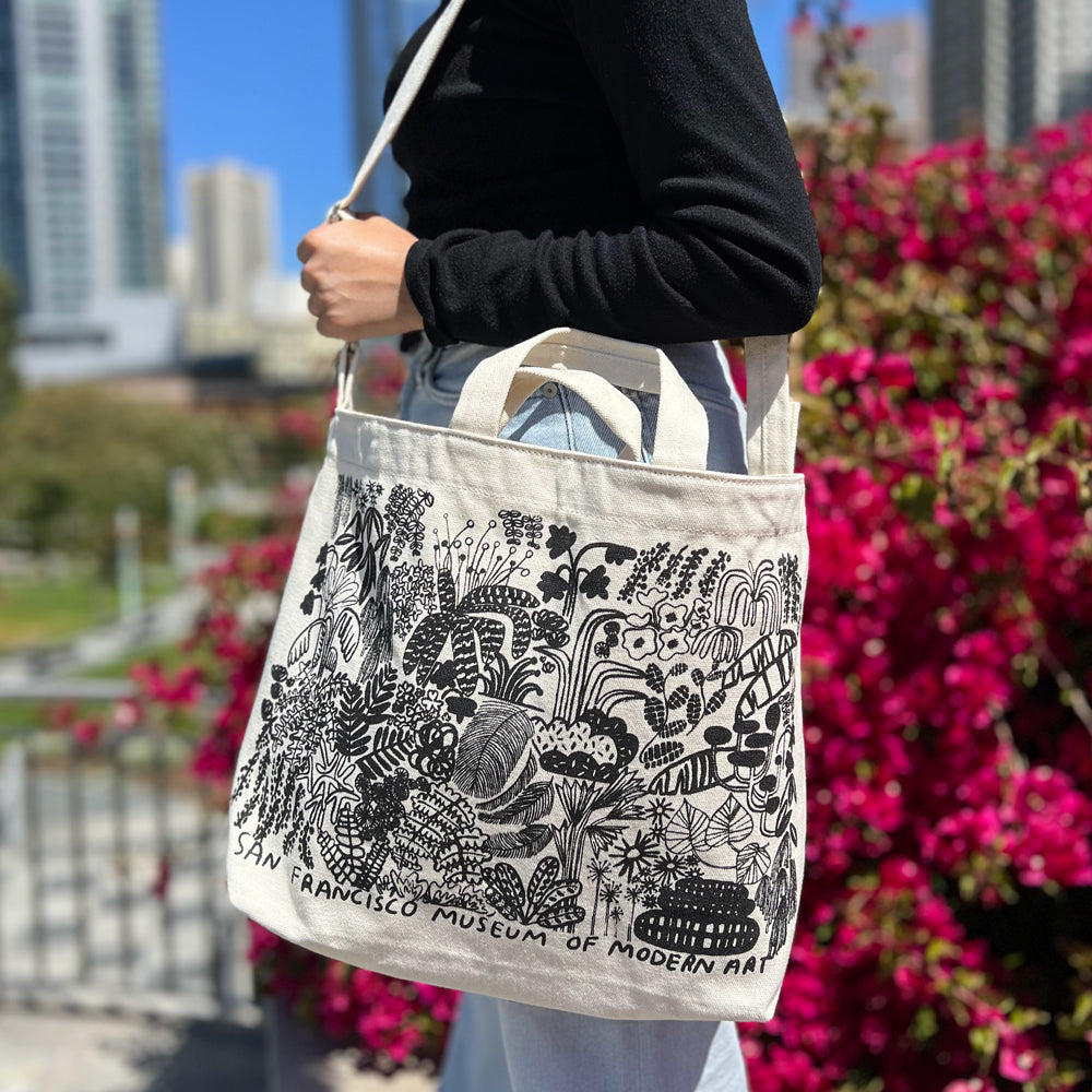 The SFMOMA x Carissa Potter Tote displayed with its with strap and handles up.