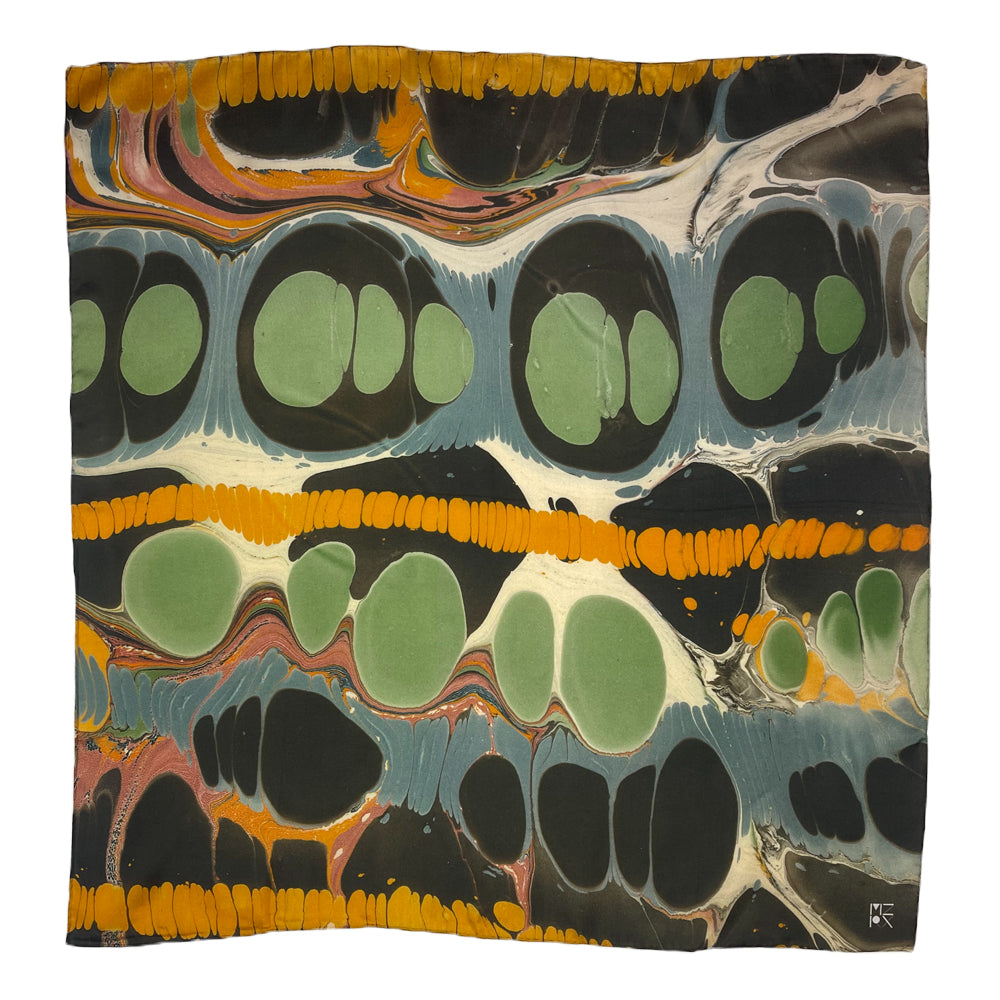 A square scarf featuring a marbled pattern with large green circles, black organic shapes, orange textured bands, and swirling blue, white, and pink details on a white background.