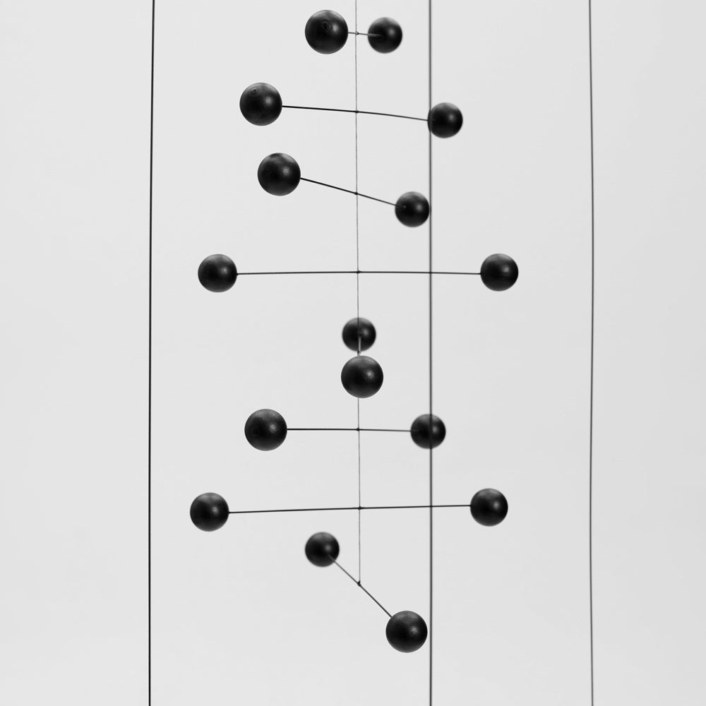 Black geometric mobile on a white background