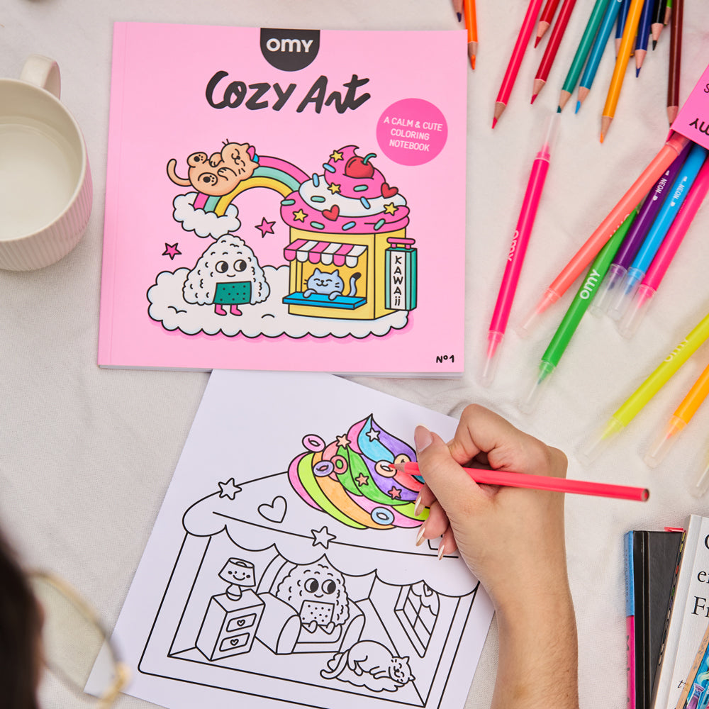 Coloring book titled 'Cozy Art' with a child coloring a page using colorful pencils.