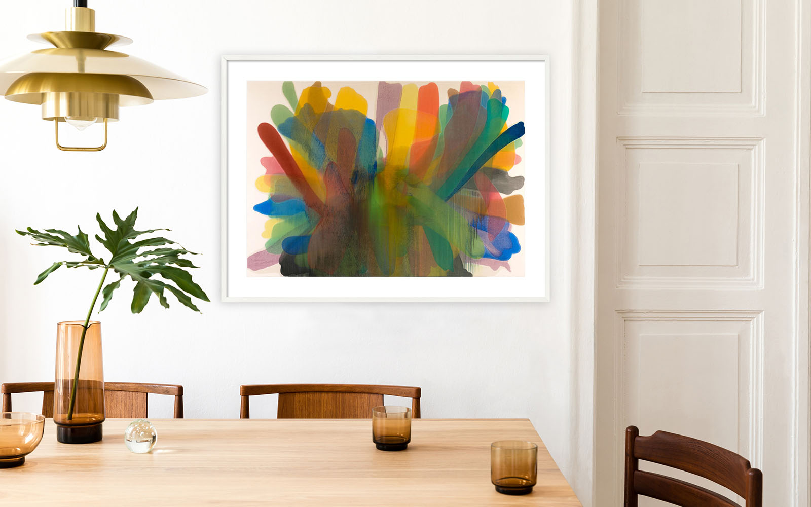 Custom framed print from the SFMOMA collection hanging on a dining room wall with contemporary design objects.