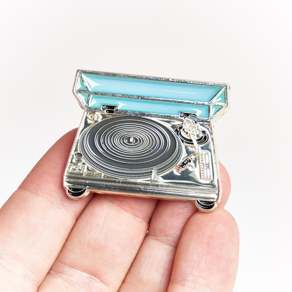 Hand holding Direct Drive Turntable Pin.