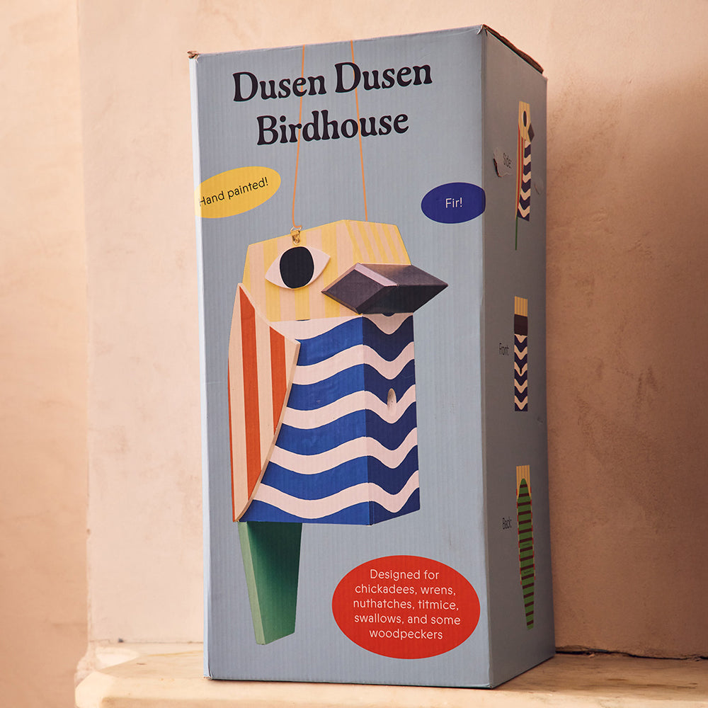 Dusen Dusen birdhouse packaging box on a beige background