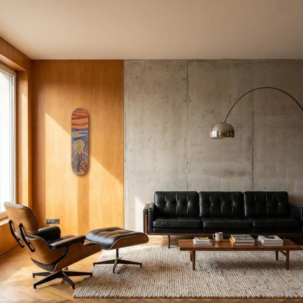 Modern living room with black leather sofa, wooden coffee table, and Eames chair.