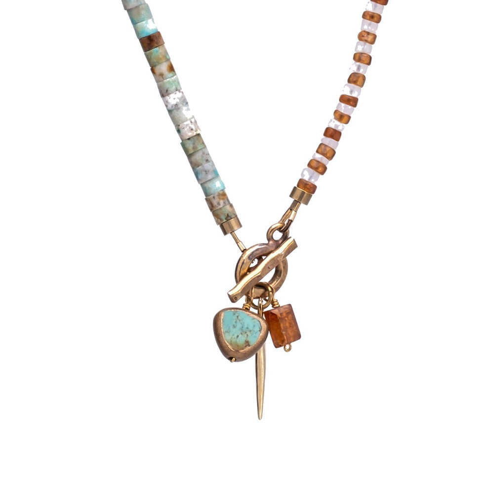 Necklace with multicolored beads and a pendant on a white background