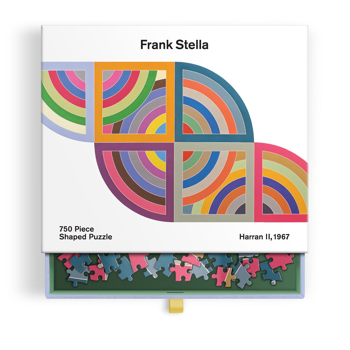 Boxed puzzle product titled 'Frank Stella' with colorful geometric artwork on the lid and a row of multicolored puzzle pieces visible in a green tray along the bottom. Text reads '750 Piece Shaped Puzzle' and 'Harran II, 1967'.