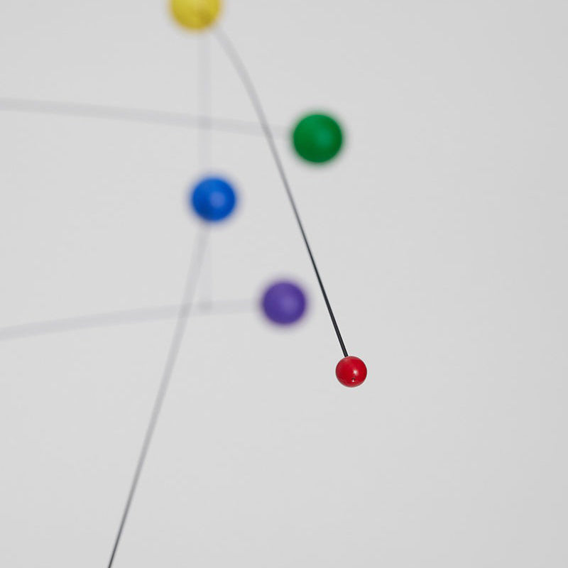 Close-up view of Futura Rainbow Mobile with blurred background.