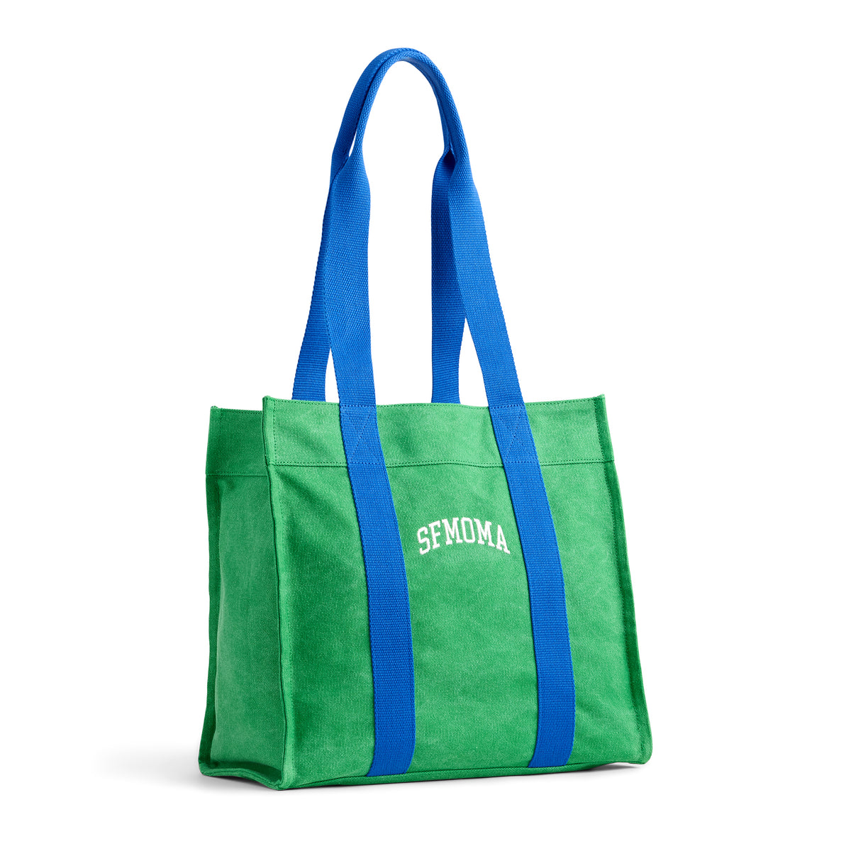 A green canvas tote bag with bright blue shoulder straps and white 'SFMOMA' lettering on the front, shown on a clean white background.