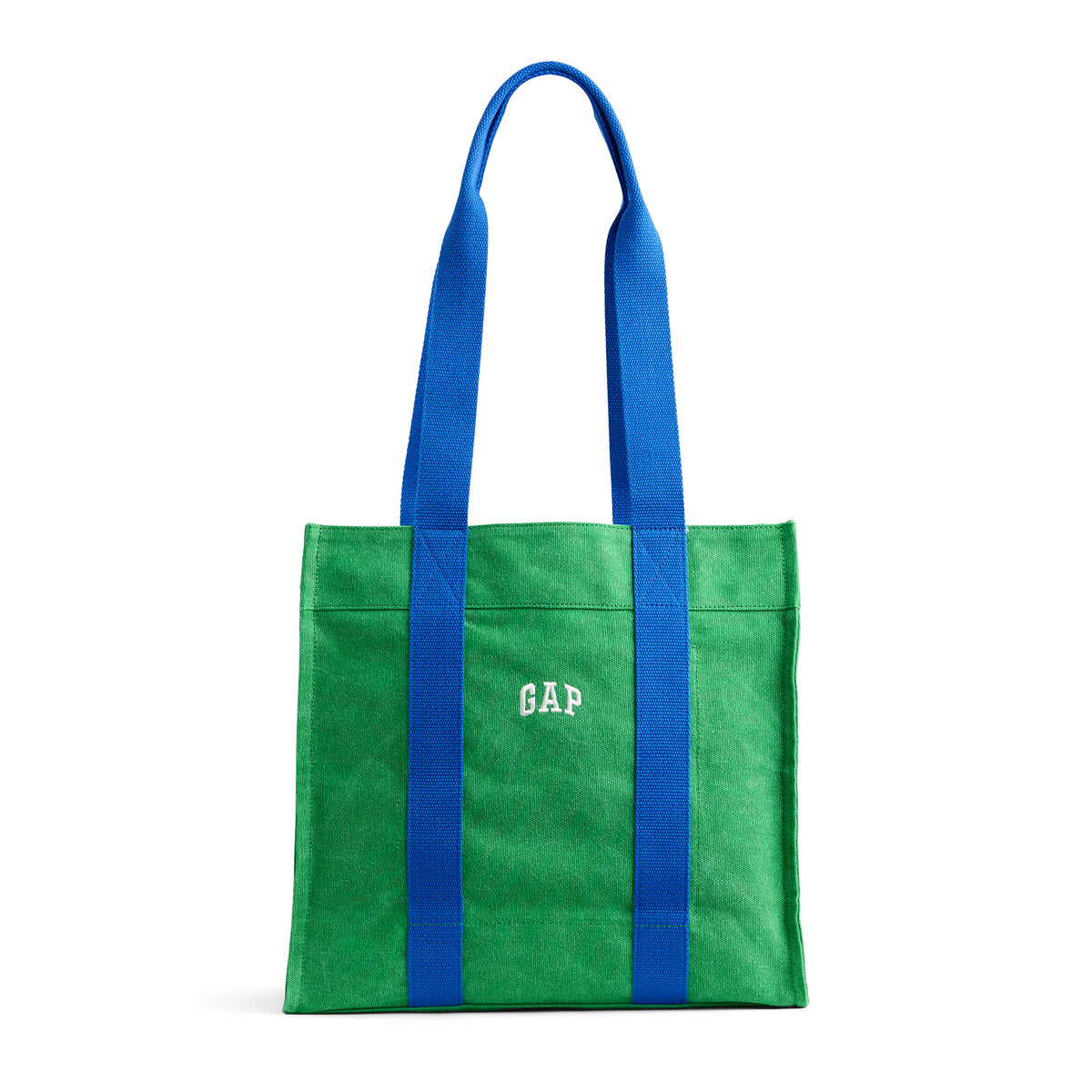 A green canvas tote bag with bright blue shoulder straps and a white embroidered 'GAP' logo on the front, set against a plain white background.