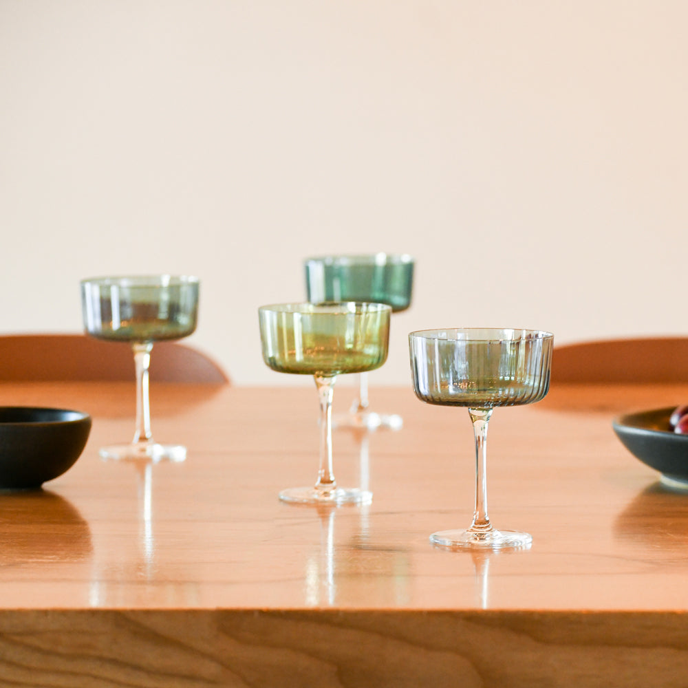 Four glasses on dining table.