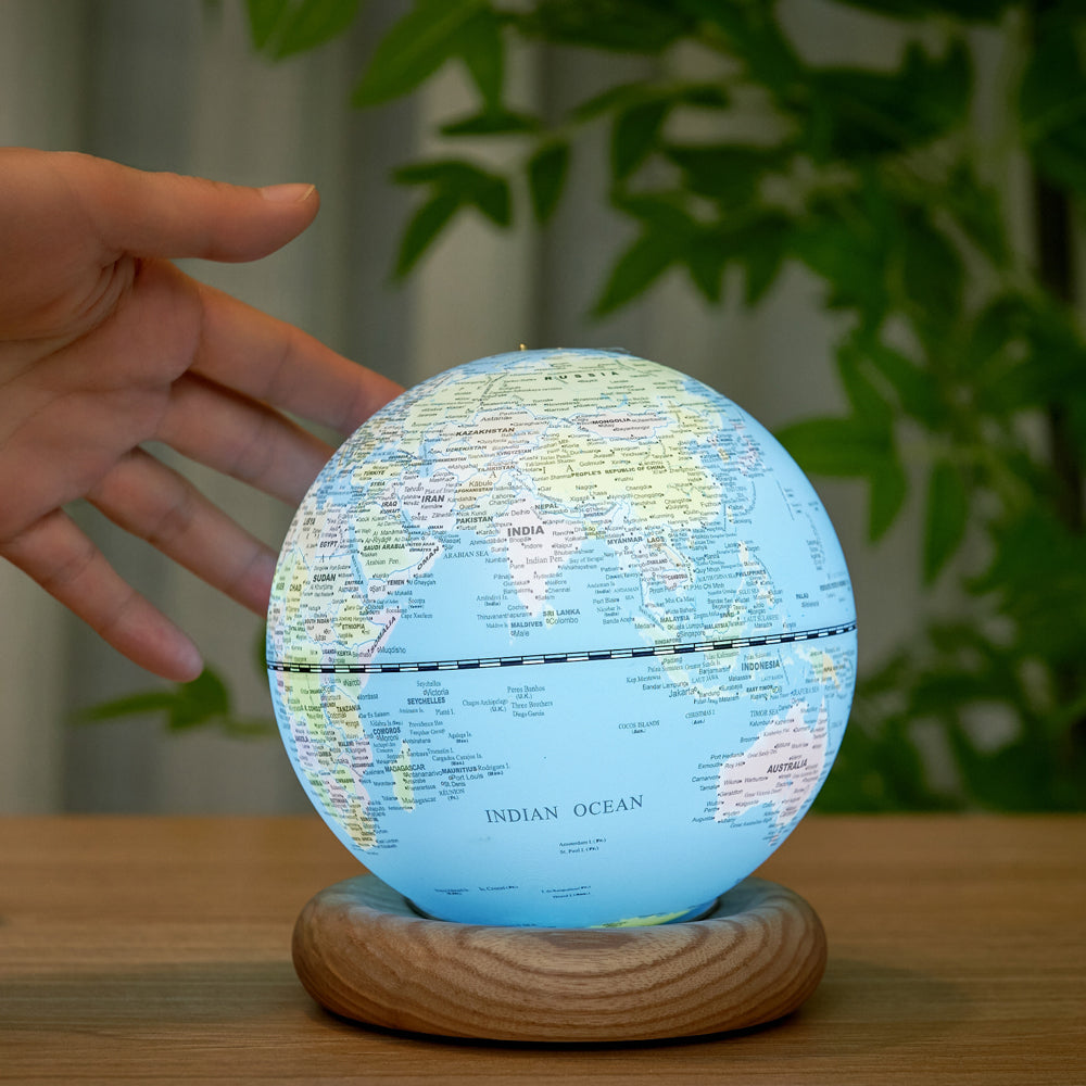 Model touching globe.