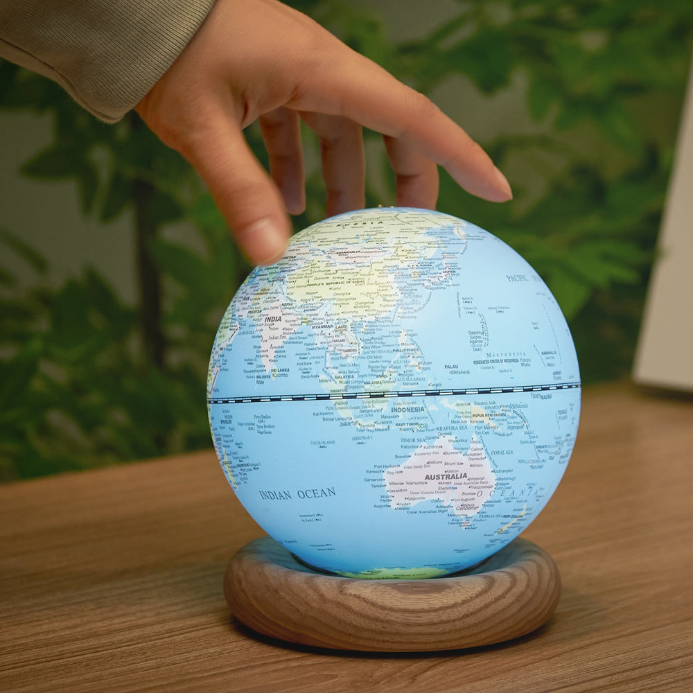 Model touching globe.