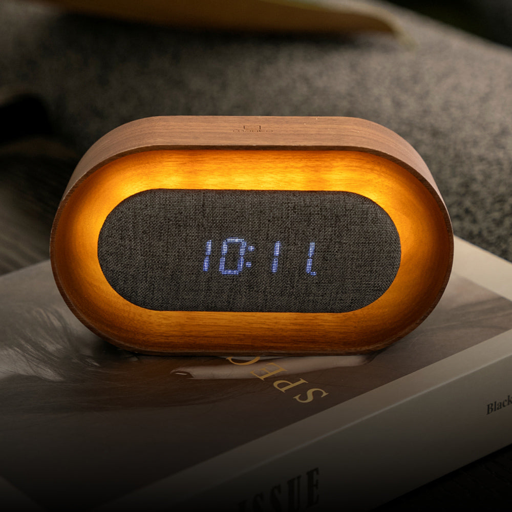 Wooden digital clock with LED display on a surface