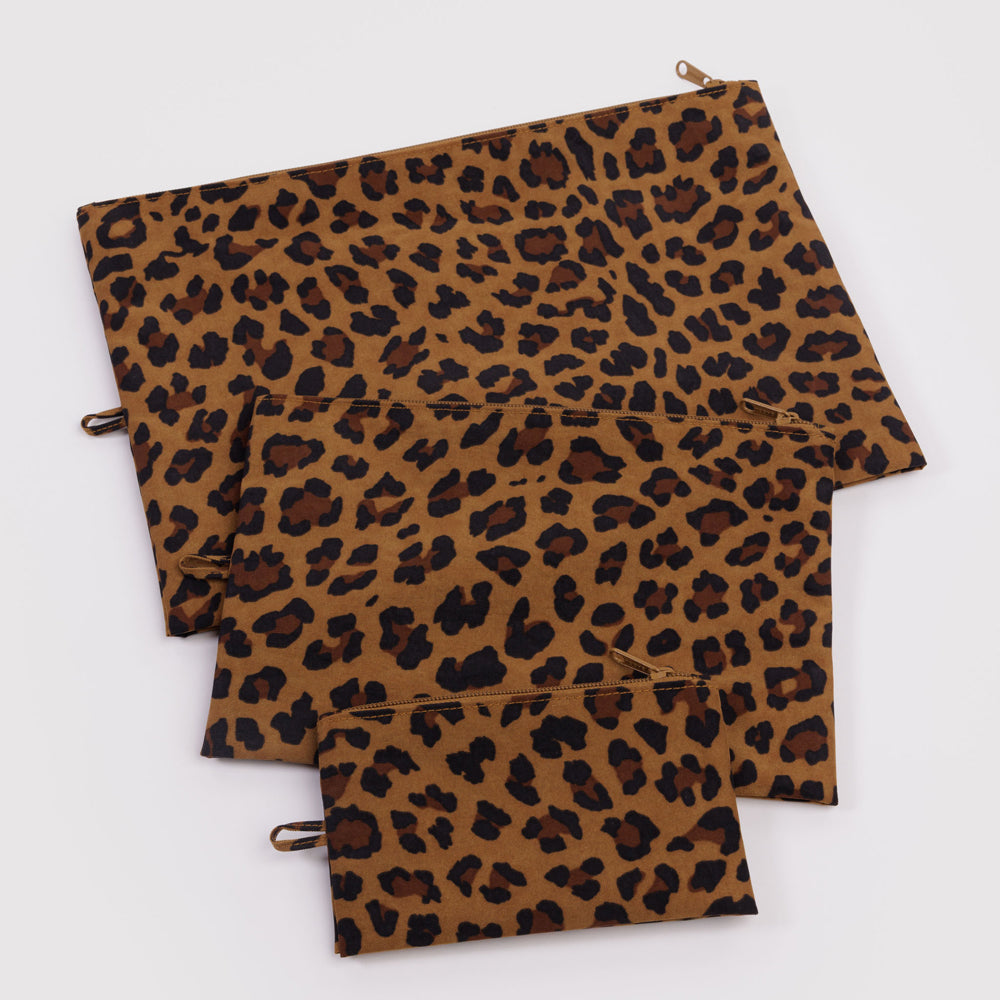 Three leopard print bags of different sizes on a white background
