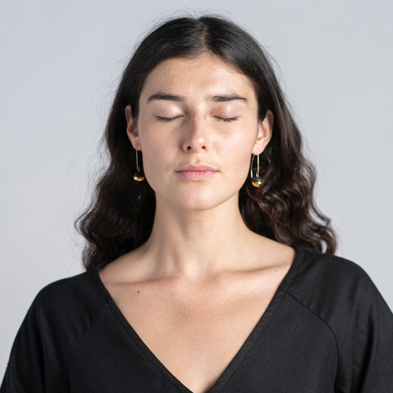 Model wearing earrings.