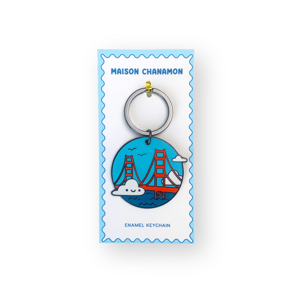 Keychain with a design of a bridge and cloud on a blue background