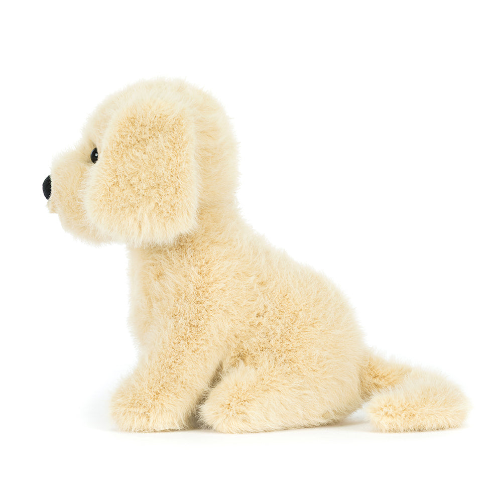 Side view. Plush toy dog on a white background