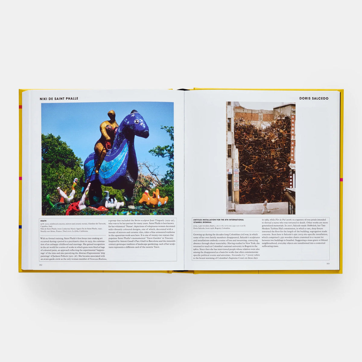 Open book showing two images of sculptures, one with a blue horse-like creature and another with a textured wall.