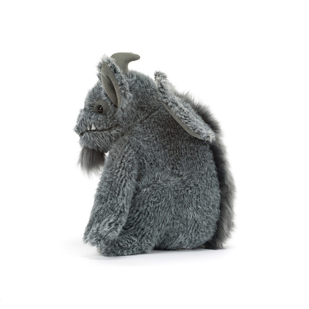 A gray plush toy with textured fur, small horns, and large floppy ears, shown from the side on a clean white background.