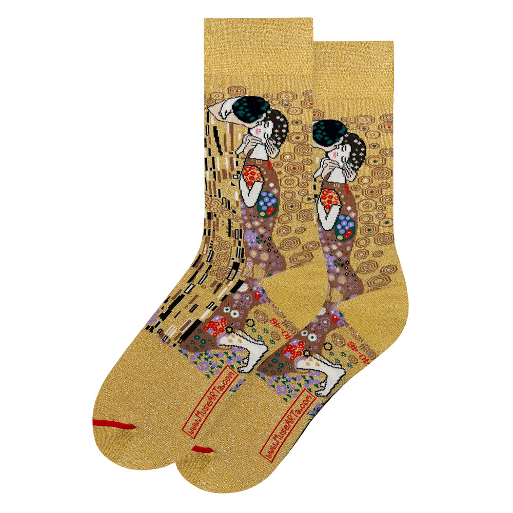 A pair of crew socks featuring Gustav Klimt's 'The Kiss' artwork in a gold glitter finish.