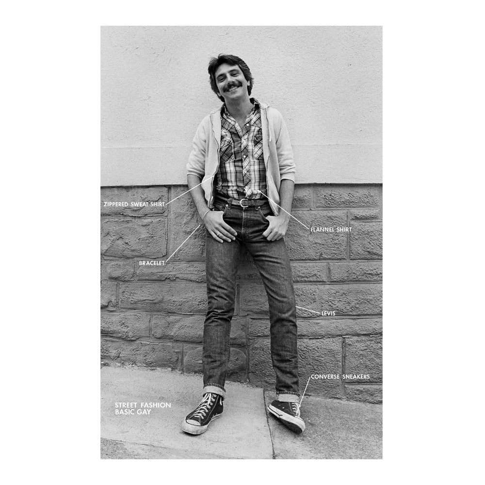 Person wearing a street fashion outfit with labeled clothing items against a brick wall.