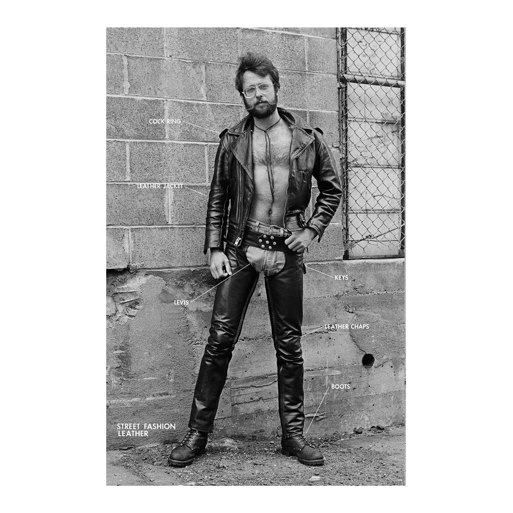 Person wearing leather outfit with labeled components against a brick wall.