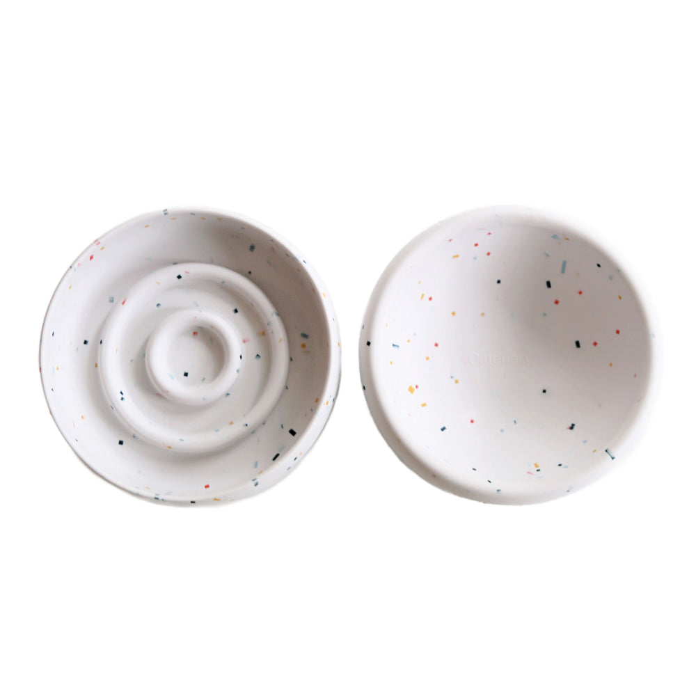 Two ceramic bowls with speckled patterns on a white background