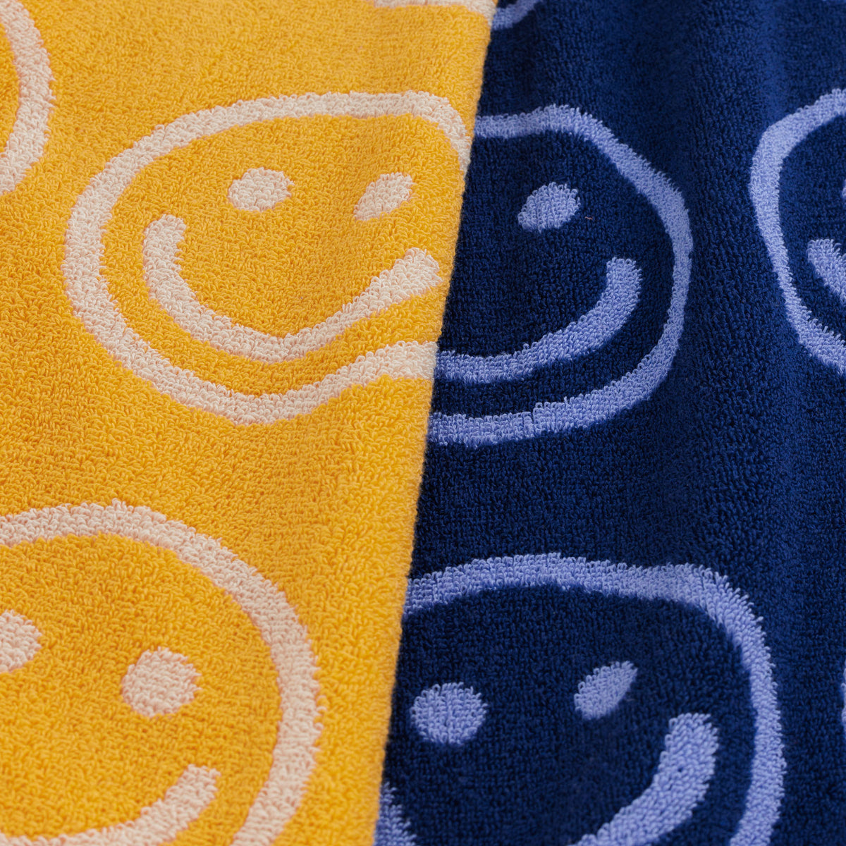 Close-up of yellow and blue fabric with smiley face patterns