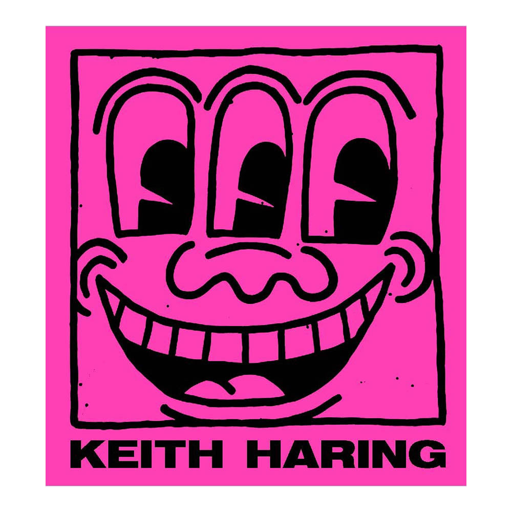 Cover of &#39;Keith Haring&#39; with graphic illustration of a three-eyed face smiling wide.