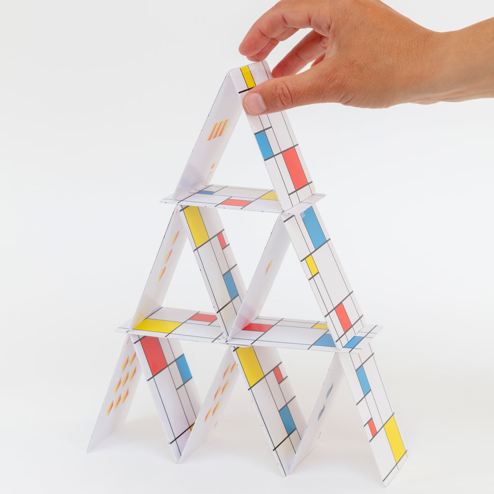 Model building pyramid with cards.