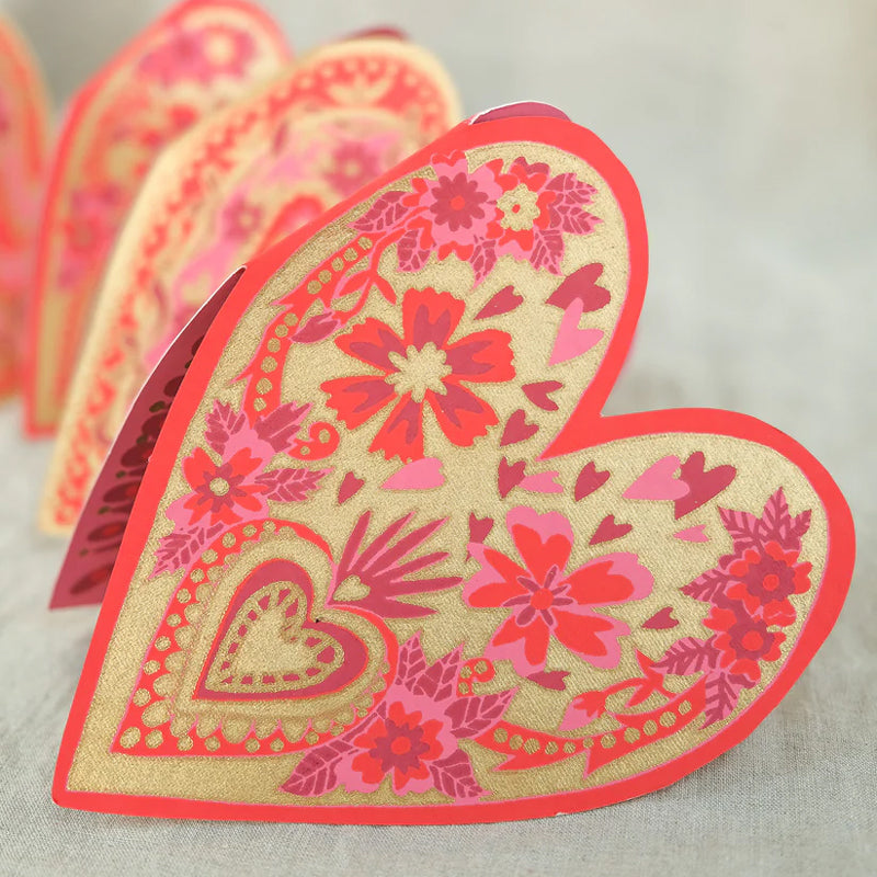 Heart-shaped decorative item with floral patterns on a light background