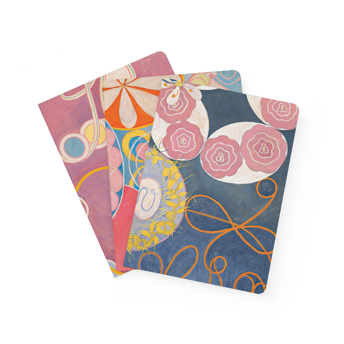 Three colorful notebooks with abstract designs on a white background