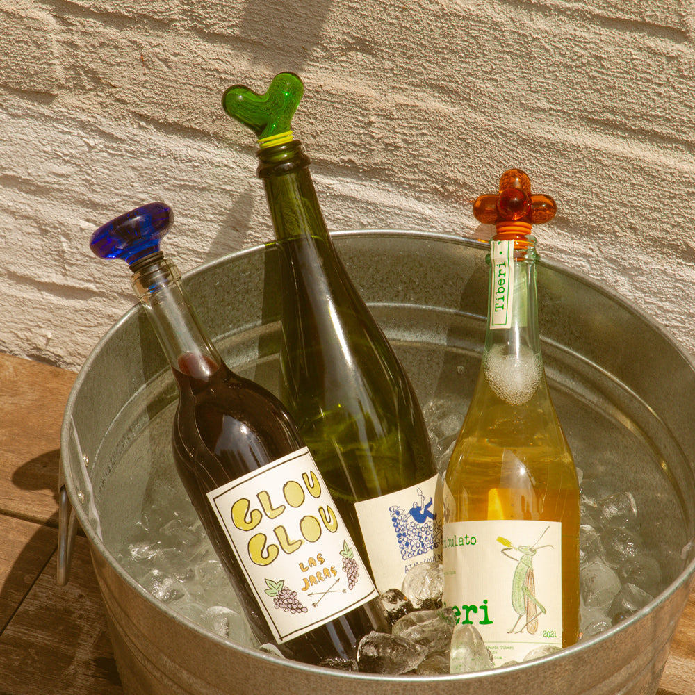 Hobknob Stopper in bottles in ice bucket.