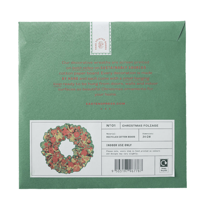 The back of a sage green recycled cotton paper pack for Christmas foliage wreath, featuring a white label with a wreath illustration and product details.
