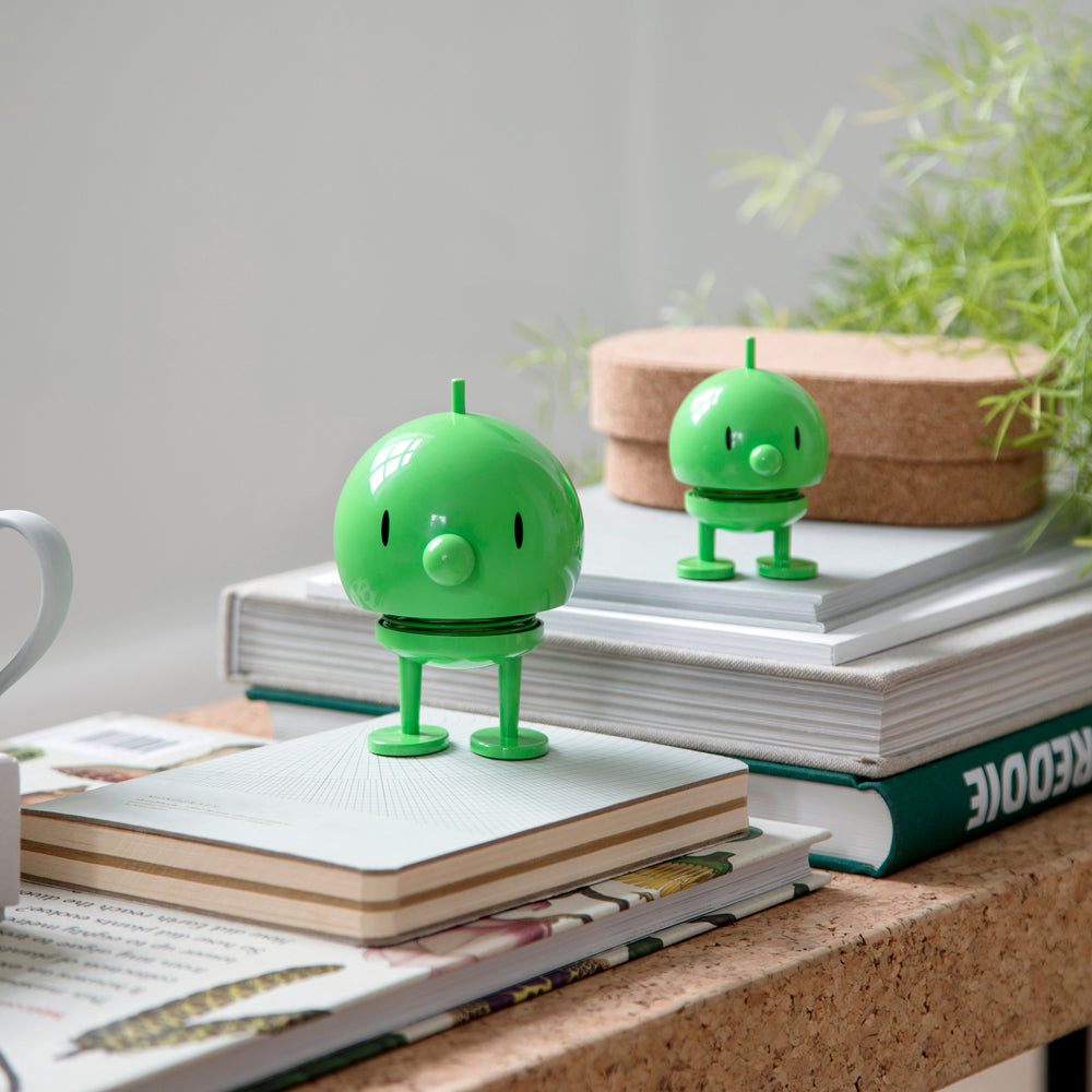 Two different Hoptimist on top of stacked books.