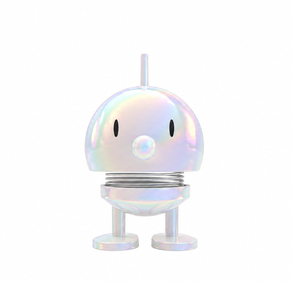 An iridescent white figurine with a metallic, holographic finish, featuring a round head, simple black eyes, a small protruding antenna, a spring-like neck, and two round legs, centered on a solid white background.