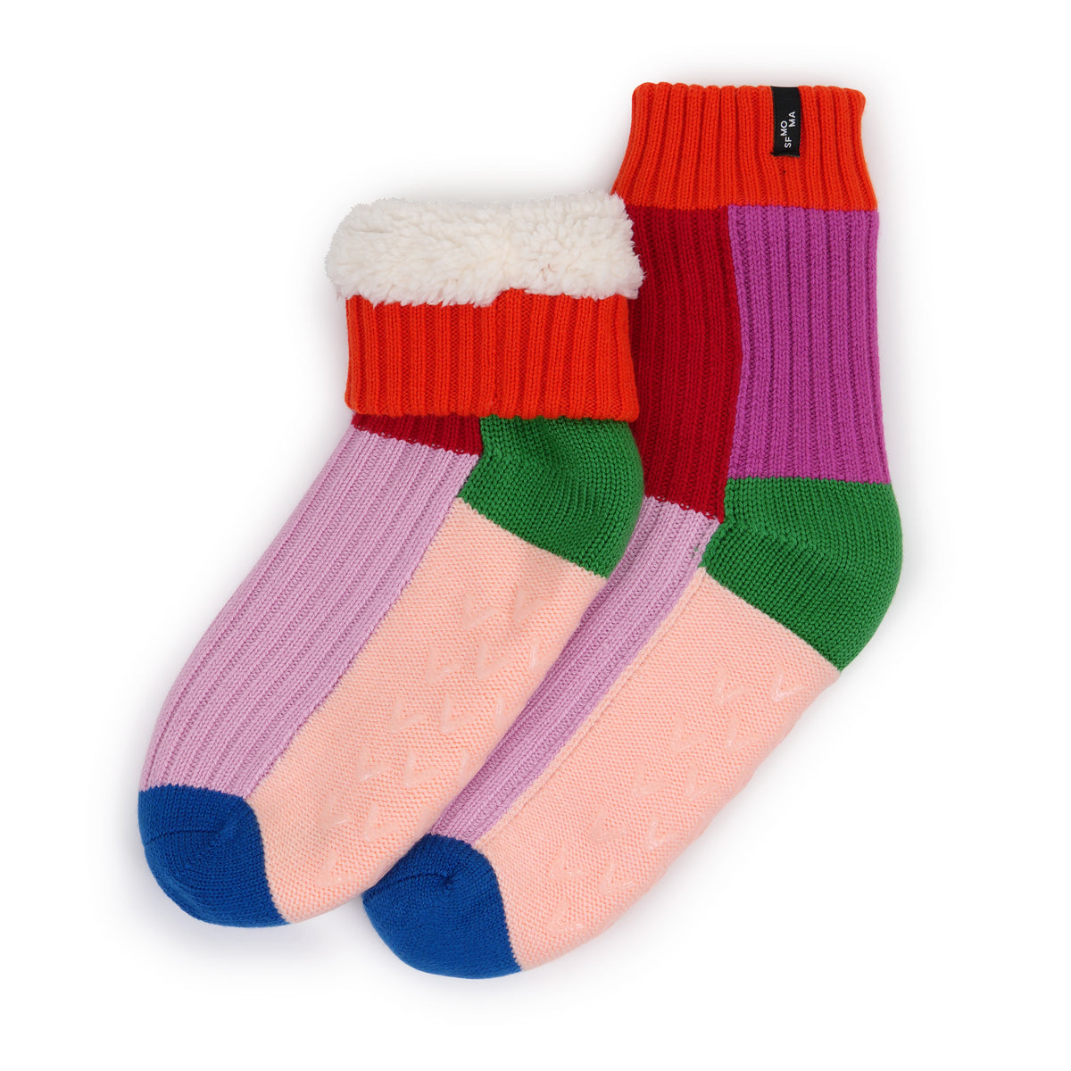 A pair of multicolor knit crew socks with a white sherpa lining at the top, featuring color-blocked sections of red, purple, pink, green, and blue on a white background.