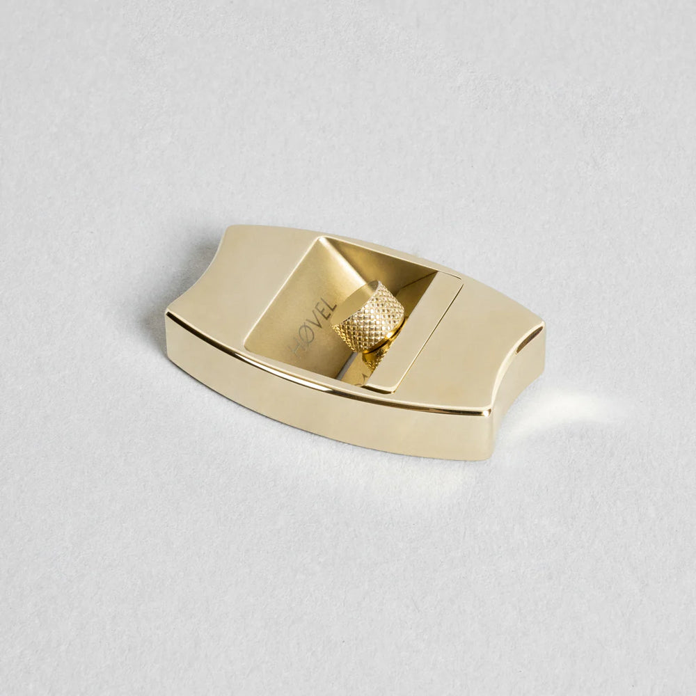 Gold sharpener on a light gray background