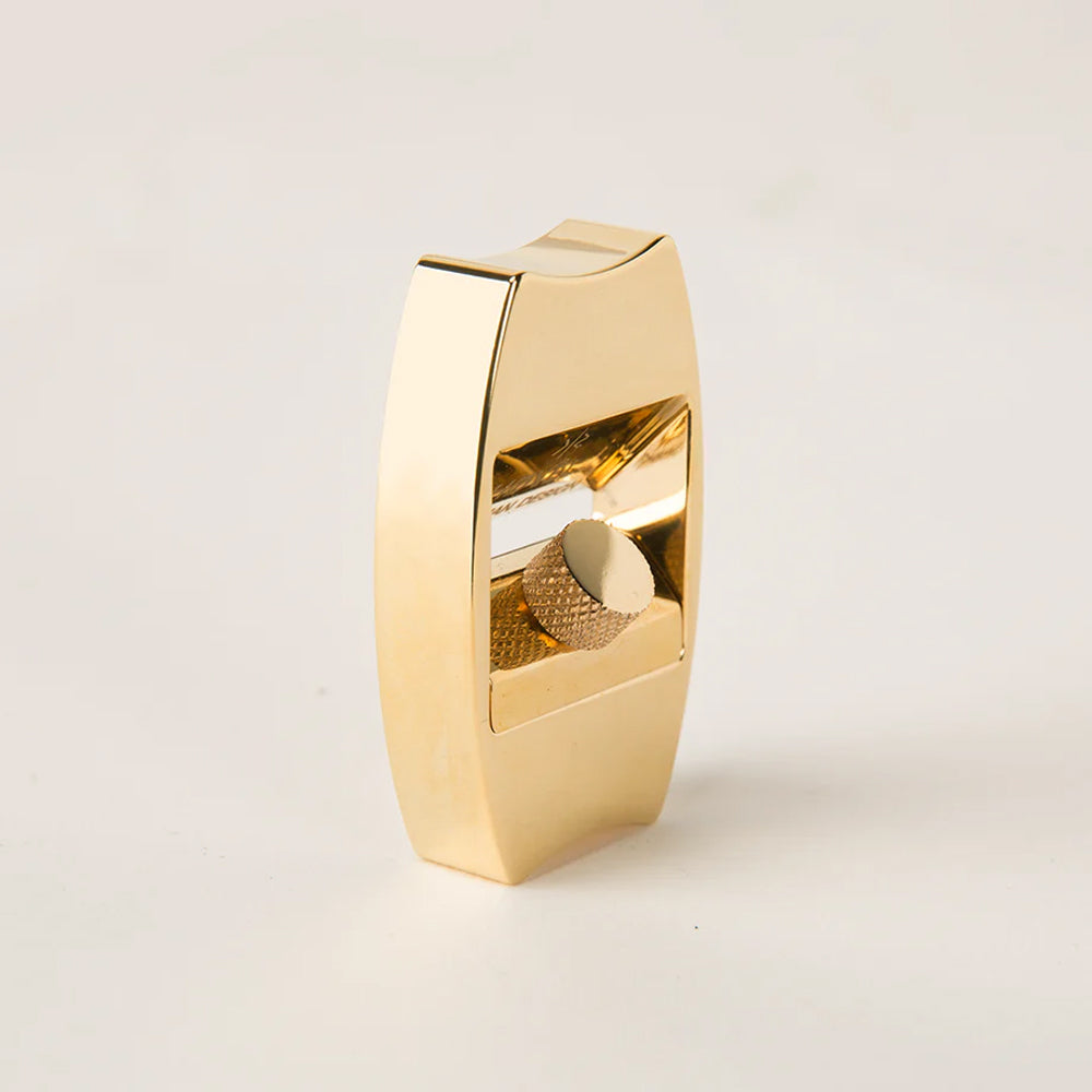 Gold metallic sharpener on a light gray background