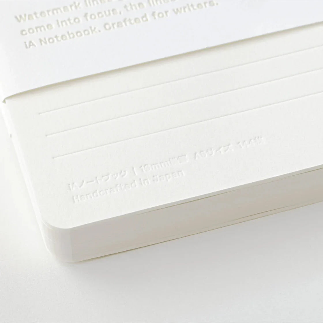 White notebook with text embossed on a white background