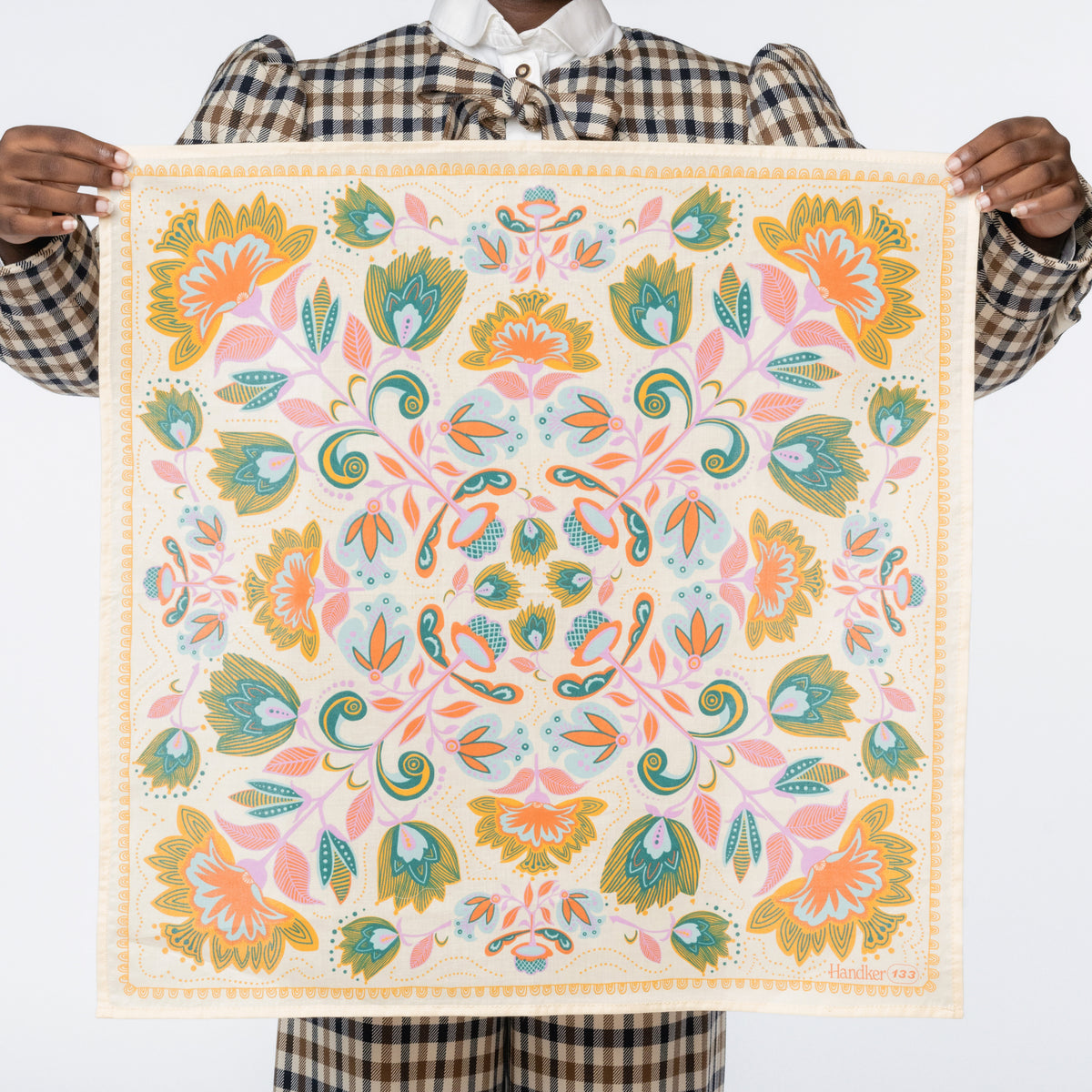 Person holding Ingrid Cream Bandana.