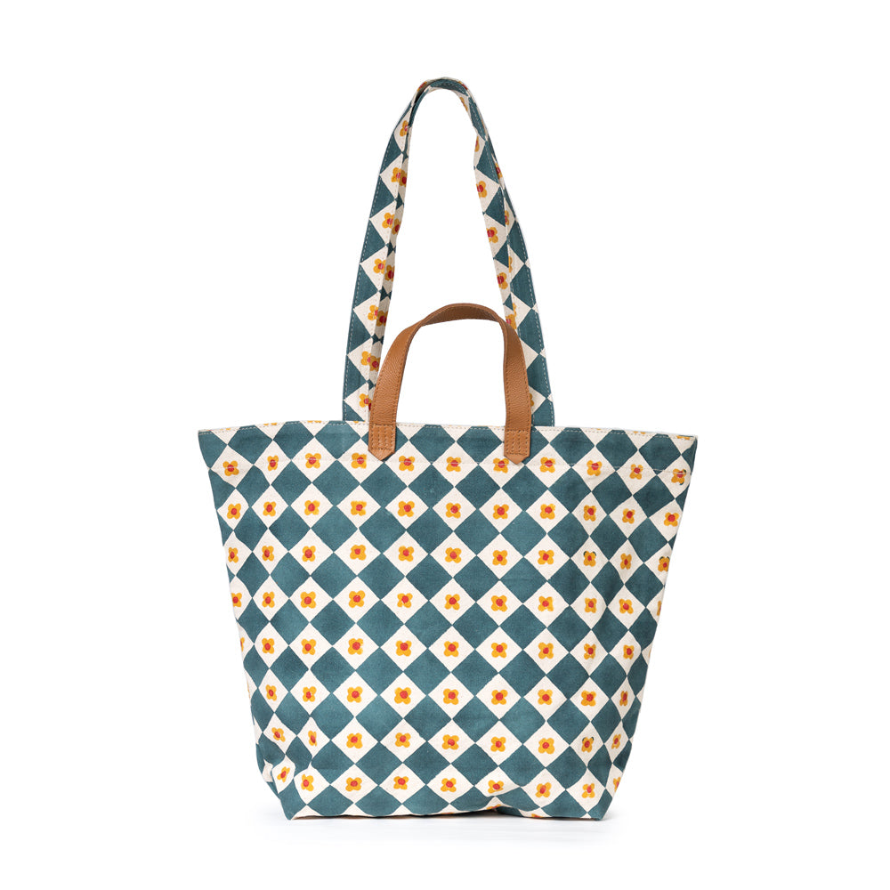 Tote bag with blue and white checkered pattern and brown handles on a white background