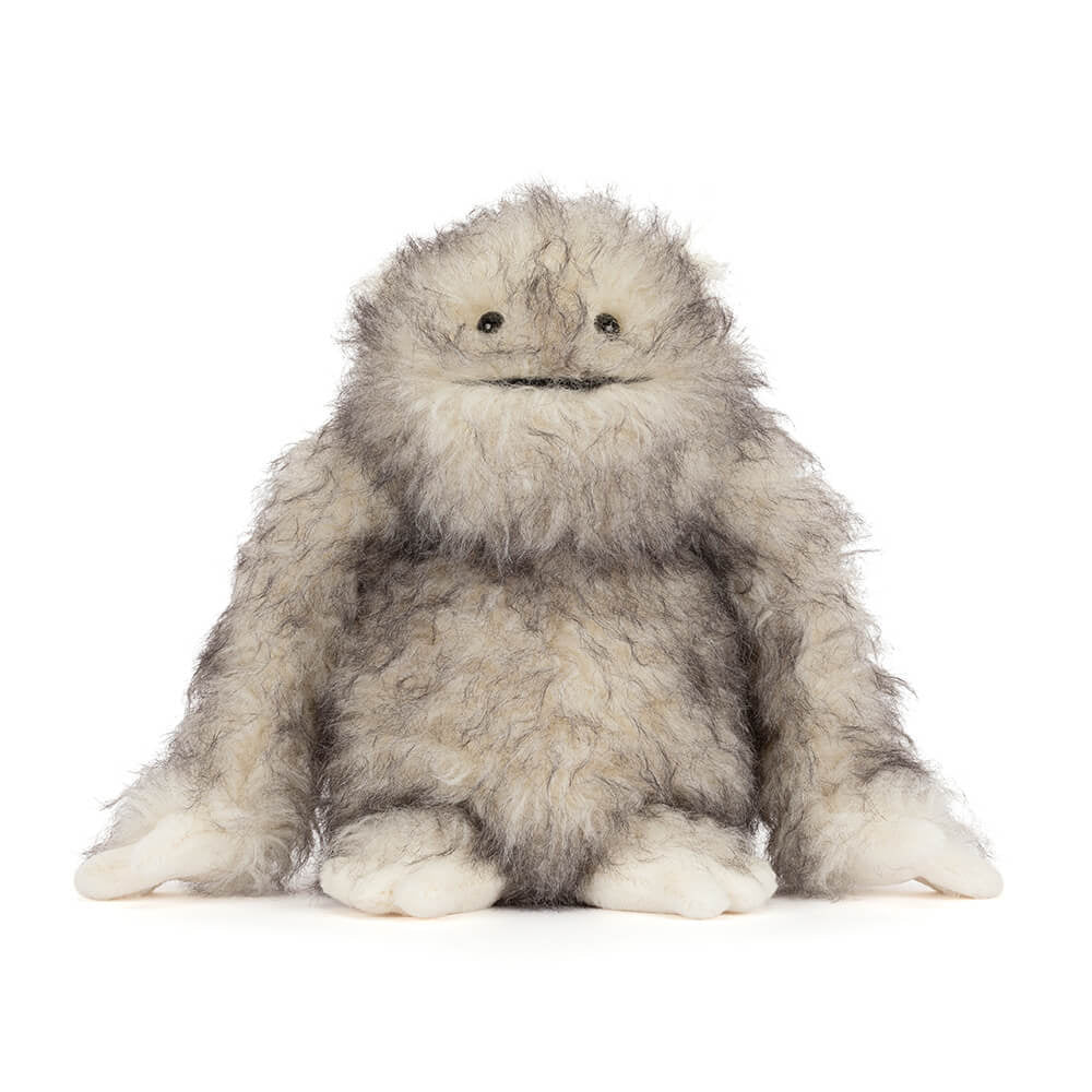 Plush toy resembling a fluffy creature on a white background