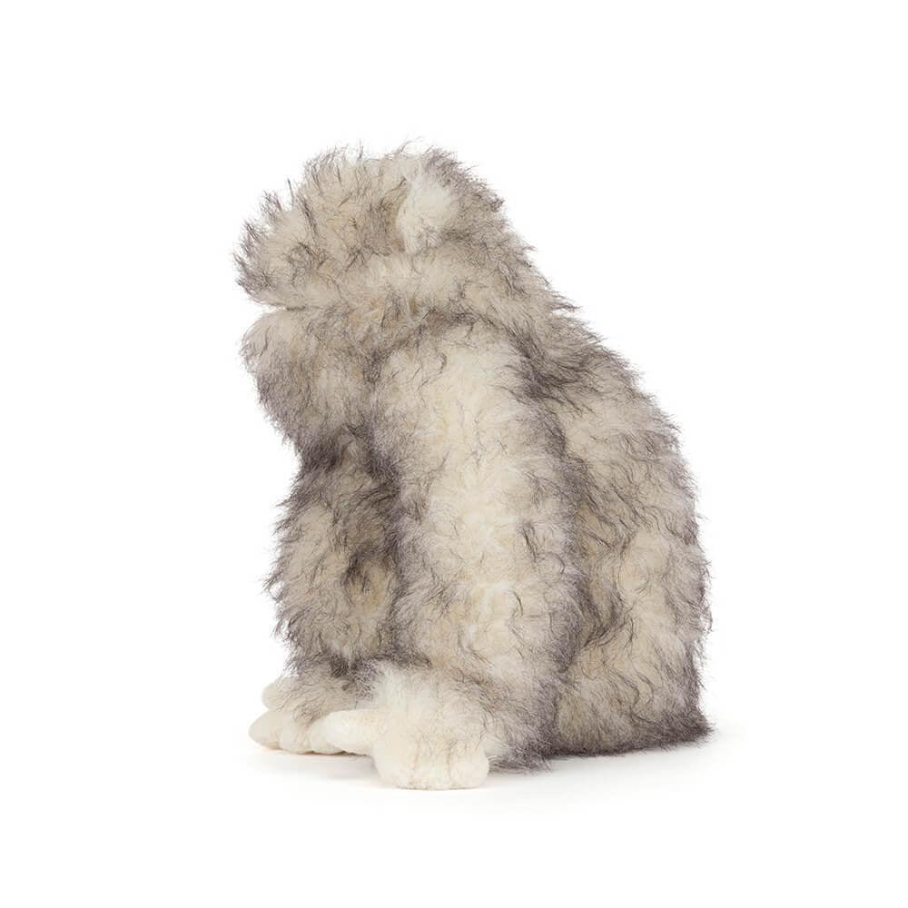 Plush toy resembling a wolf on a white background