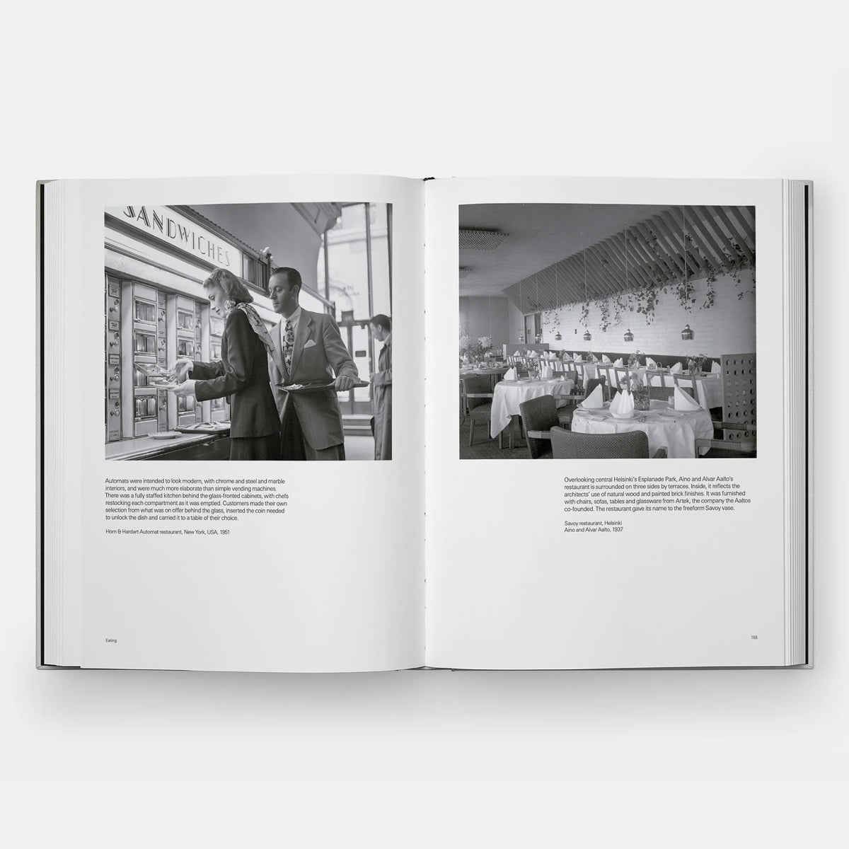 An open book showing two black-and-white printed pages with photographs and blocks of text, photographed against a light gray background.