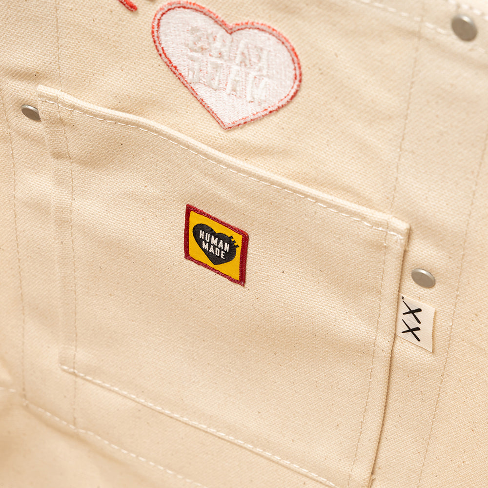 Beige fabric with a heart-shaped patch and a label on a pocket